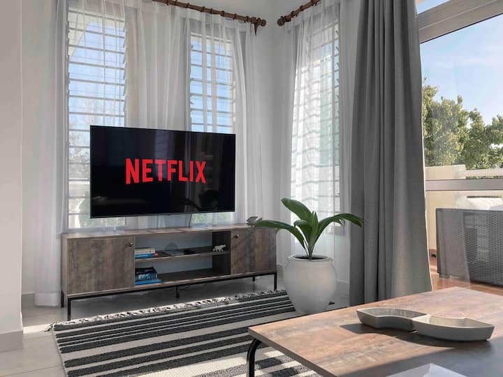 Shijo seritë e tua të preferuara të Netflix në një televizor 50"me ekran të sheshtë direkt nga divani i madh.