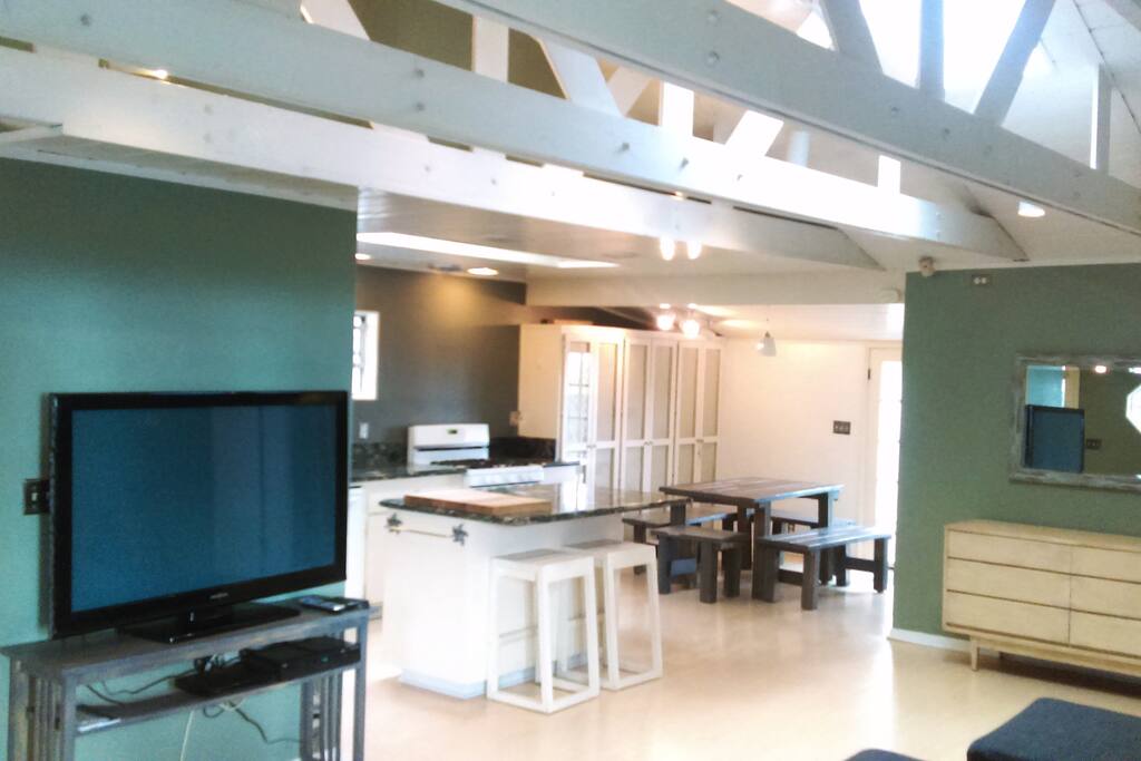All can lighting mounted onto the exposed rafters with tongue and groove ceiling.