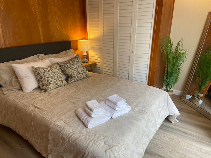 Queen bed with a sliding door to access the enclosed backyard. 