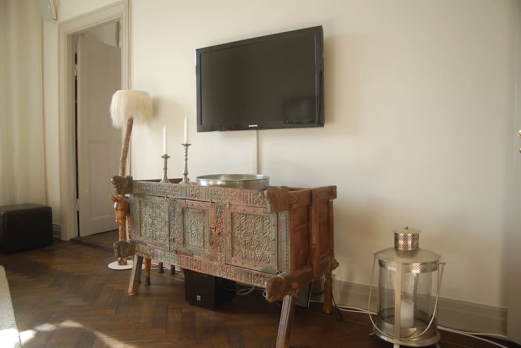 Living room, dvd player and TV amplifier/receiver hidden in the old Tibetanian cupboard