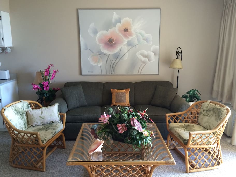 Peaceful living room with queen-sized sofa bed, from which you can see the ocean