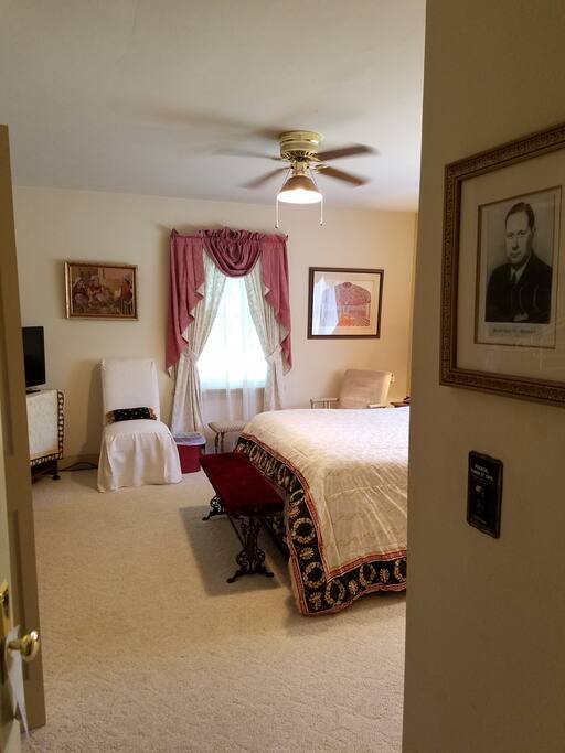 Entrance into the Burton Y. Berry Room. Flat screen TV, desk, 2 chairs, bench, closet, ironing board, iron