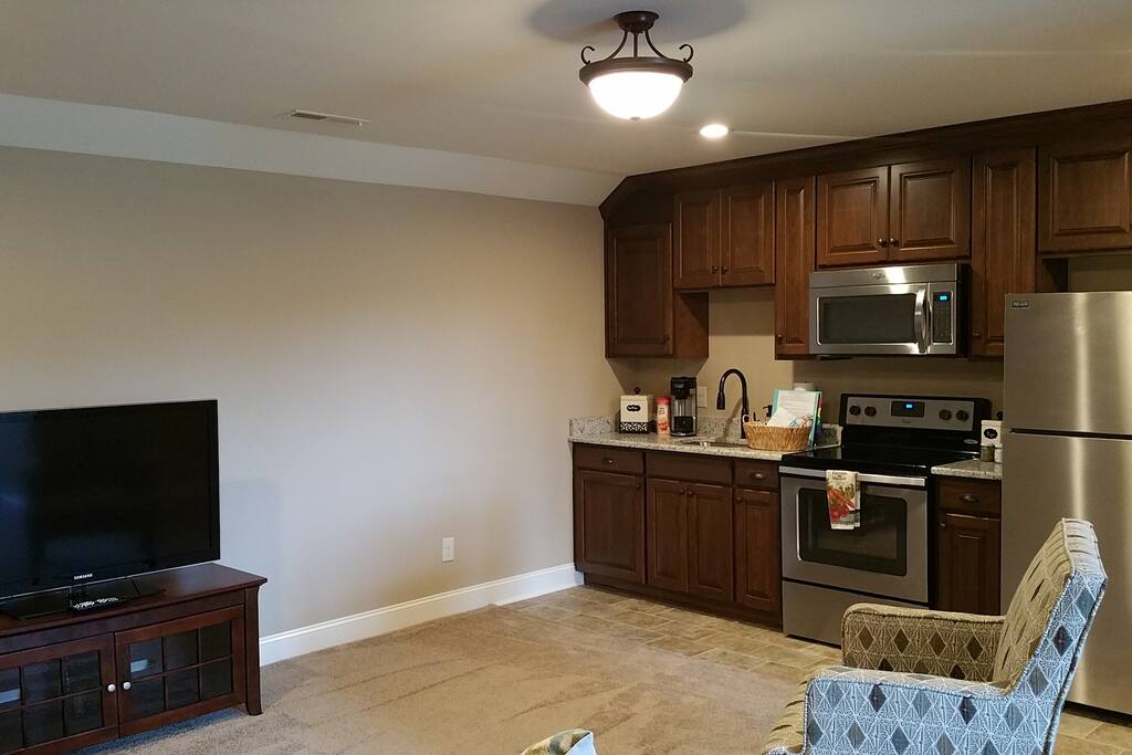 Full Kitchen Complete with Microwave, Oven, Full Sized Fridge, Sink and Toaster.