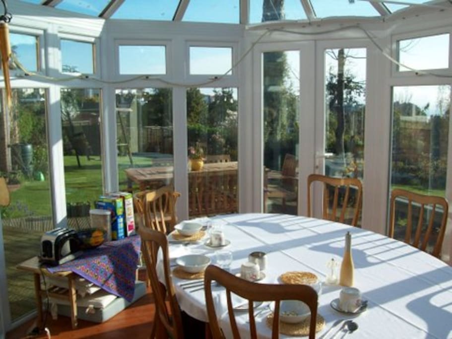 Breakfast is served in the conservatory with views over the garden and to the sea beyond