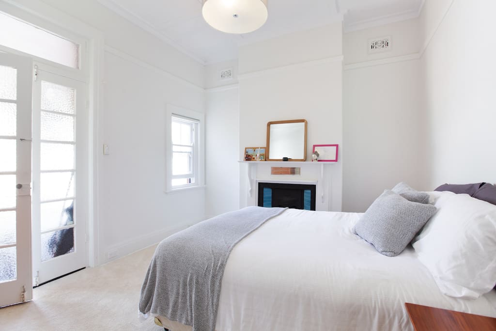 Bright master bedroom with heritage fireplace