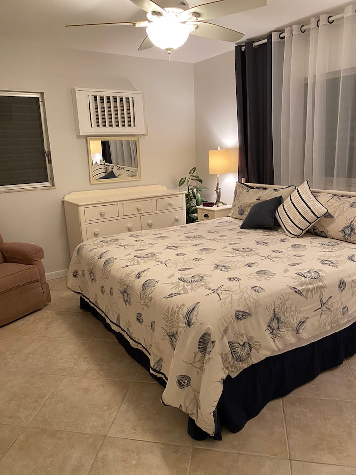 Beautifully decorated master bedroom with a king size bed, two large closets, and a flatscreen TV.
