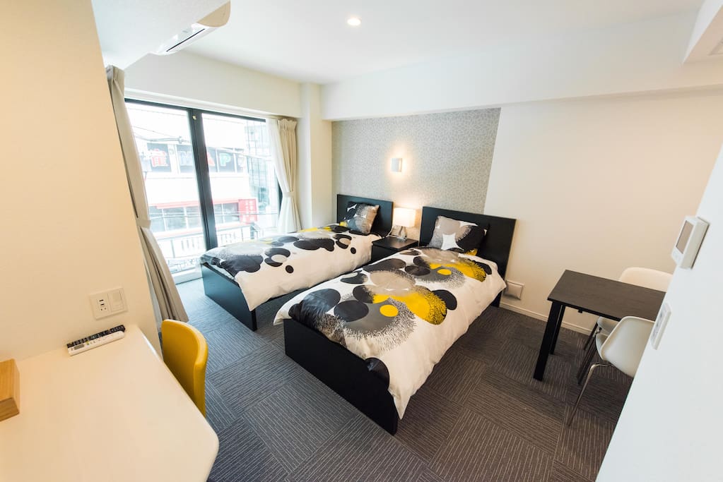 Bedroom with 2 single beds and natural sunlight