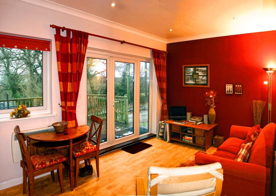 Lounge, dining table and french windows onto veranda