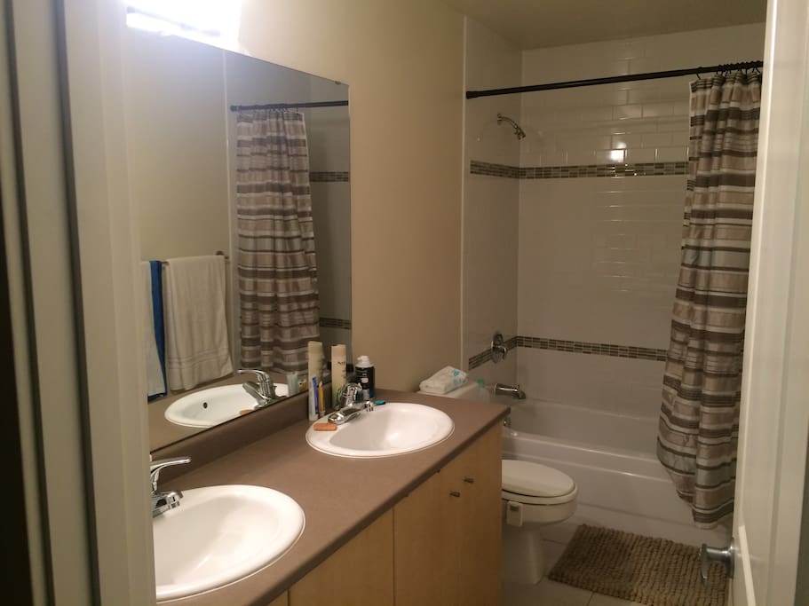 Clean, brightly light shared bathroom. You'll very likely have it all to yourself during your stay.
