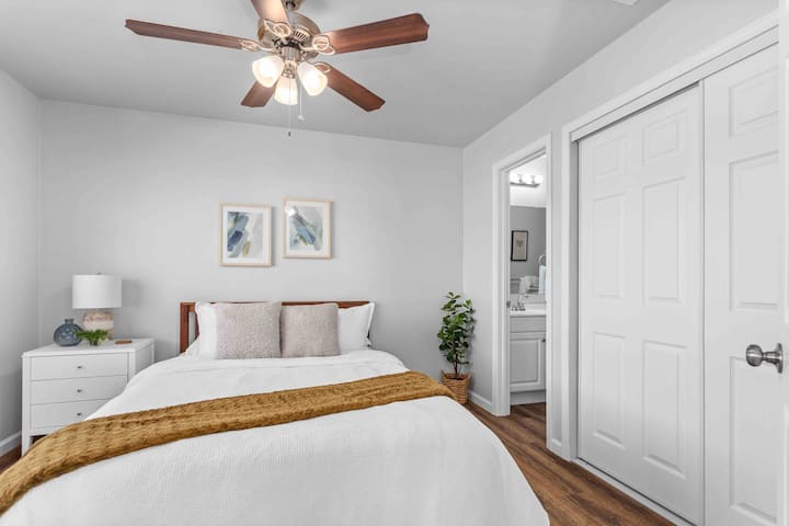 Master bedroom with attached bathroom. Bed is a queen size mattress. 