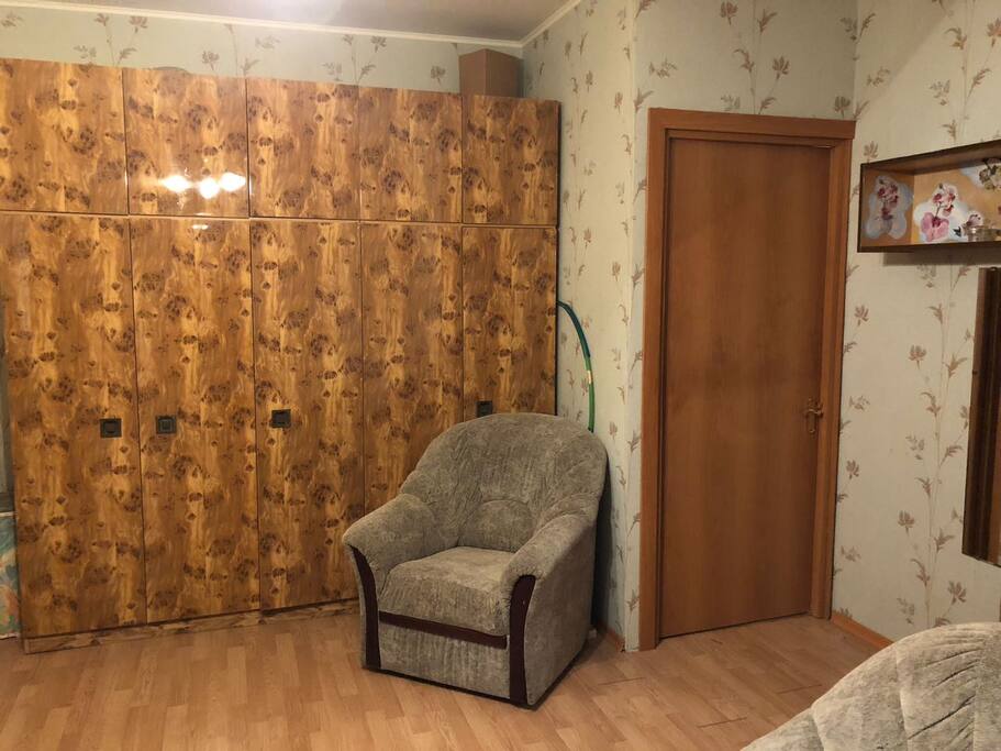 Большой вместительный шкаф, кресло, дверь в коридор