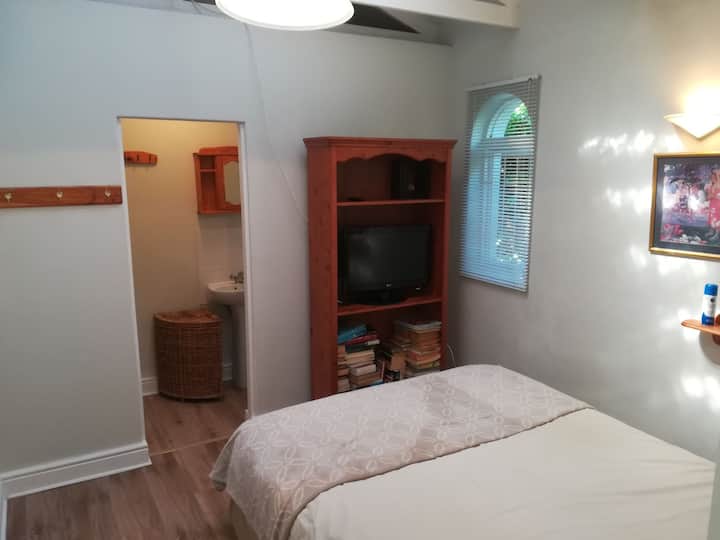 מיטת קווין סייז עם חדר רחצה צמוד. 