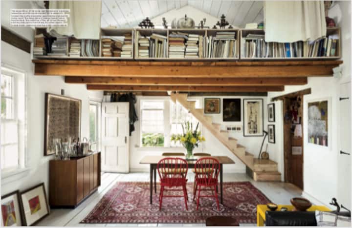 The elegant dinning table with a sleeping Loft above Filled with art at Art Chapel. 