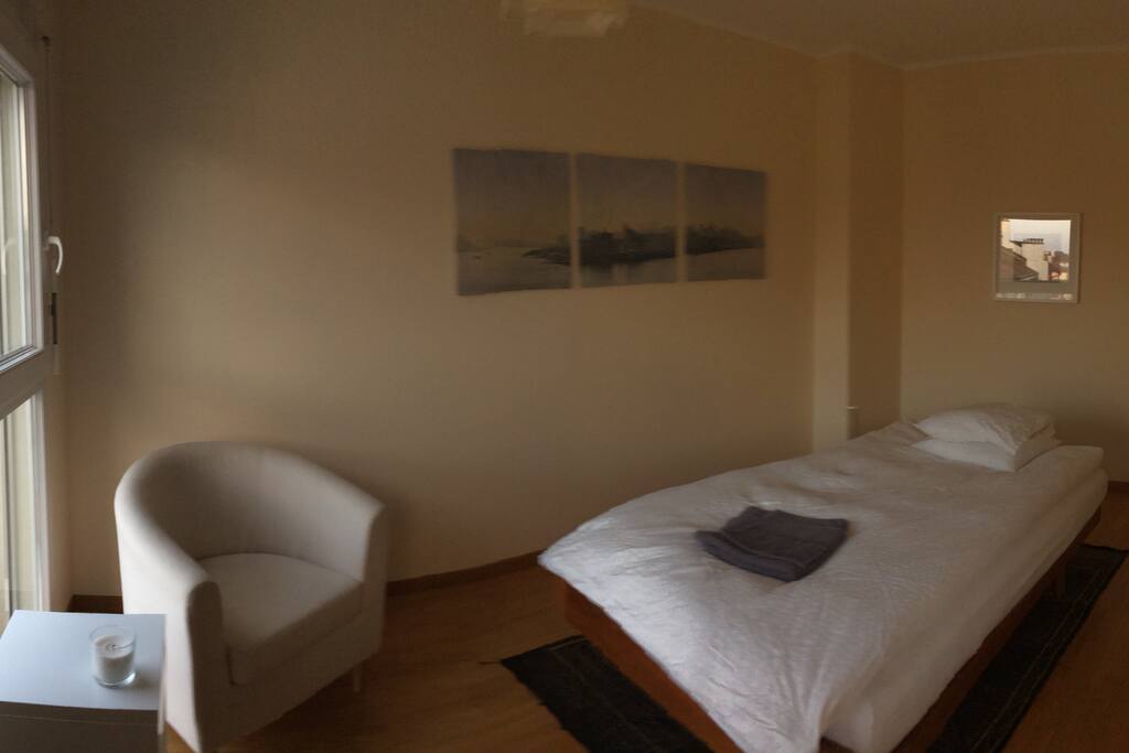 The bedroom (room 1) with Swisscomfort bed and reading chair.