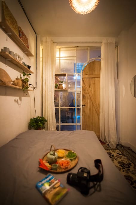 Lovely bedroom with full of cute and stylish stuffs and furniture - a corner where you enjoy your stay at the fullest as a local. Wide window right down to main street of Hang Giay