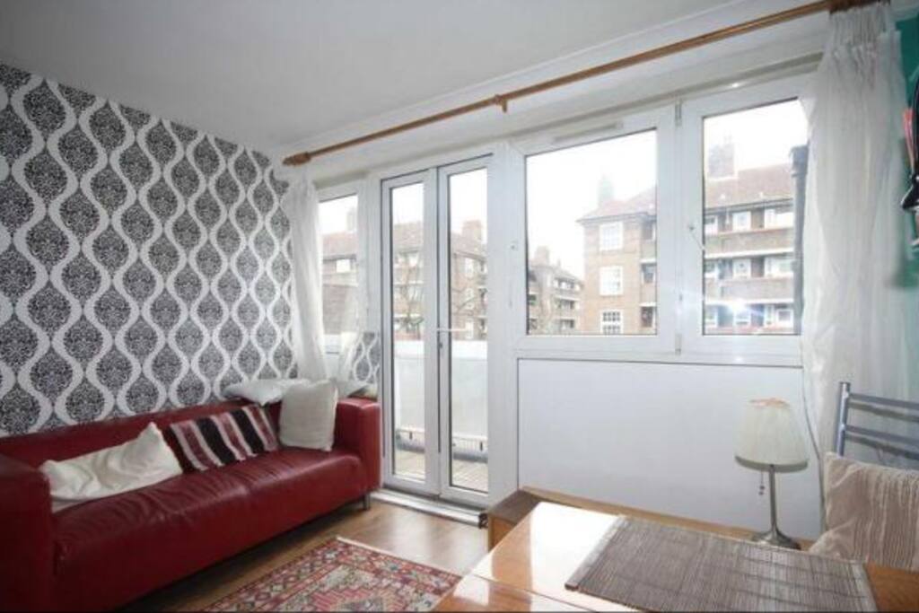 Living room with dining table and chairs, sofa, coffee table.