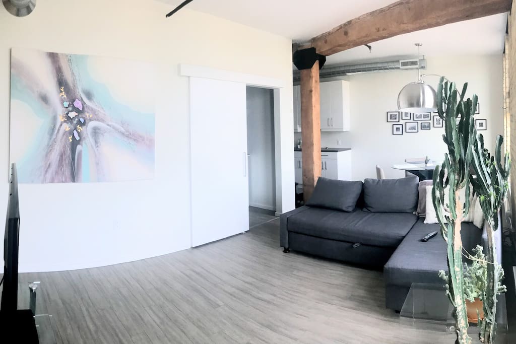 Beautiful open concept with historic beams running throughout. This couch pulls out to sleep two, for parties of four staying!