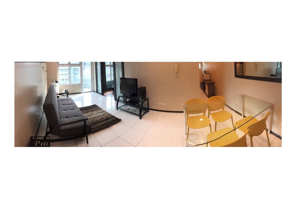 Open plan living space with sliding doors to separate the bedroom; tucked kitchen to the right