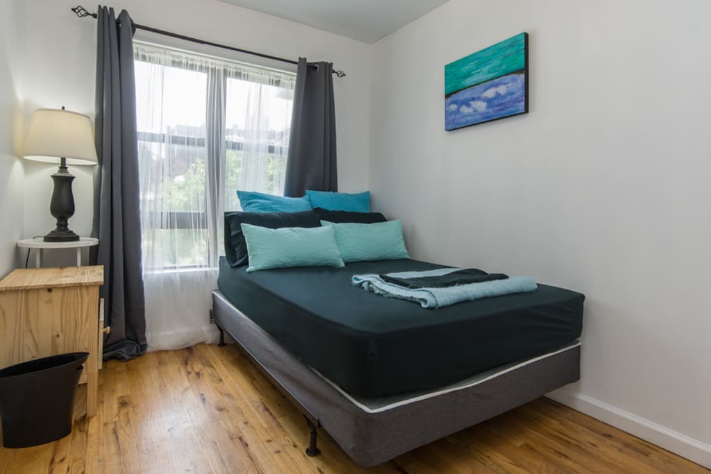 clean comfortable bedroom with yard view and closet