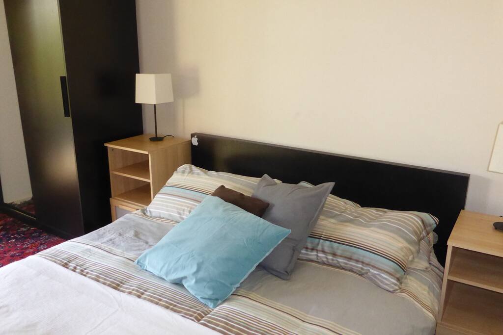 The Queen size Bed and wardrobe is seperated from the main room with a curtain