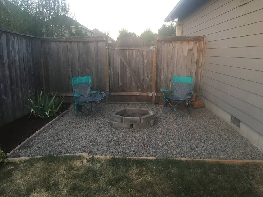 Fire pit with chairs and wood provided.