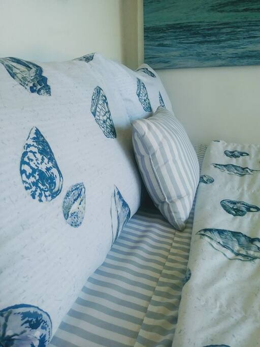Your guestroom in the lush garden behind the house. French doors to open wide with view to the palm trees and parrots
