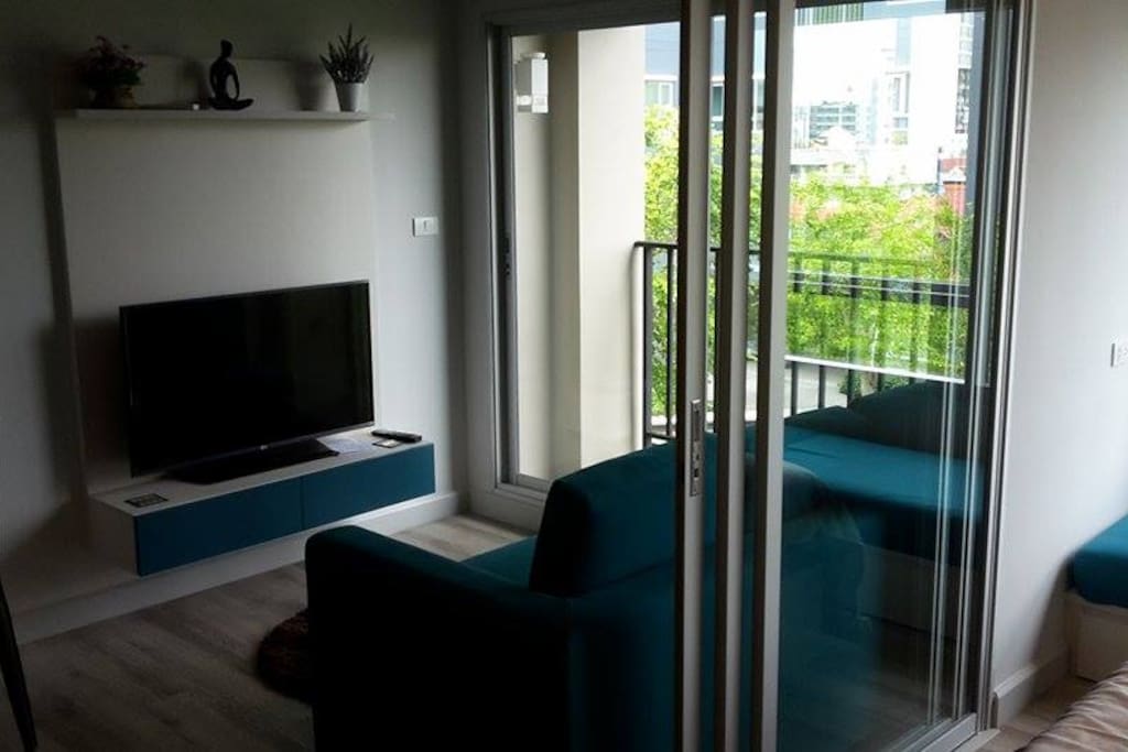 Lounge with 43 inch smart tv with true gold tv package. Sliding doors to bedroom.