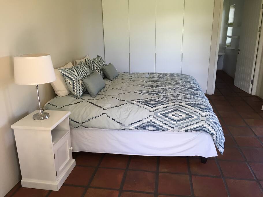 The first bedroom contains plenty of cupboard space and a king-size bed that can be made into two twin beds on request. This room has an adjoining full bathroom and terrace access.