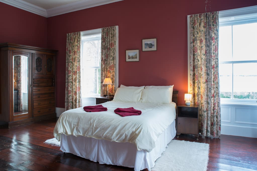 King bed with antique wardrobe.