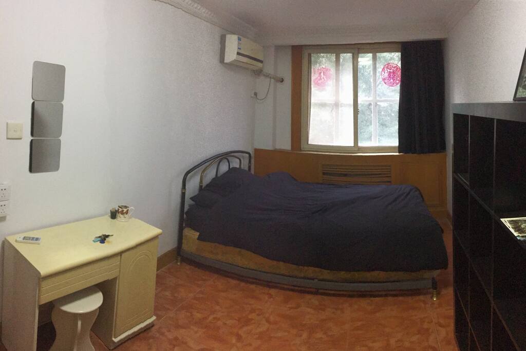 Queen size bed, desk and stool. Large bedroom with AC