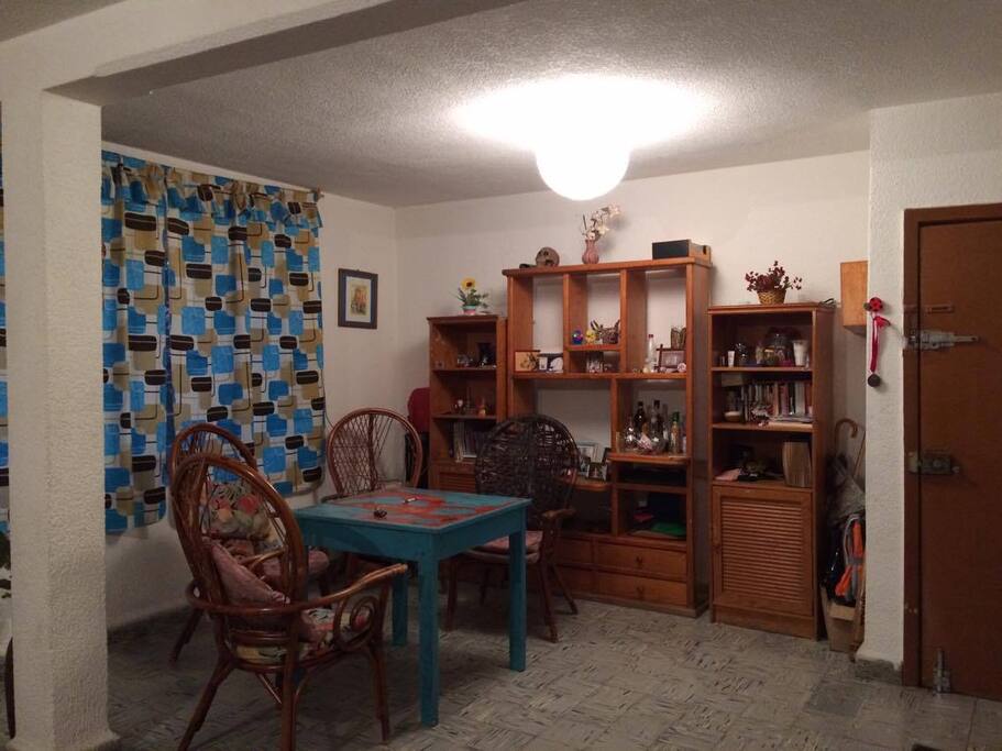 Large dining room that is next to the room that is wide and enters quite light during the day.
