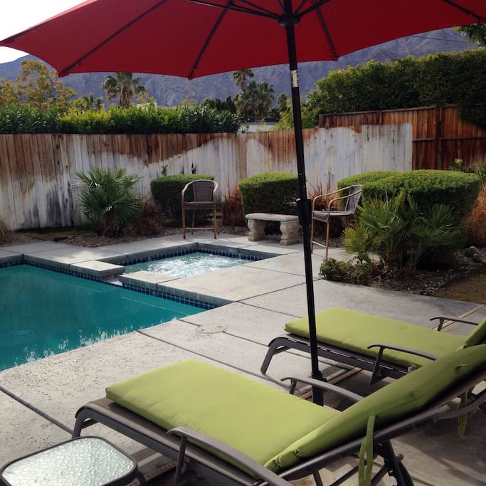 Poolside lounge chairs with umbrella.