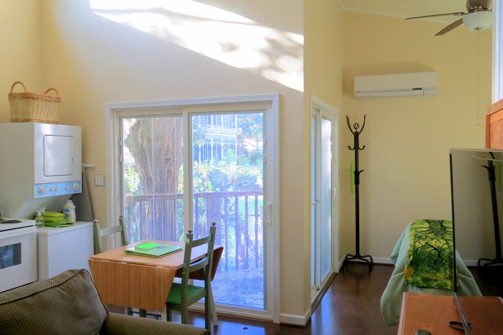 View from bathroom door looking toward main living area. Two sets of sliding doors open to the TreeHugger deck.