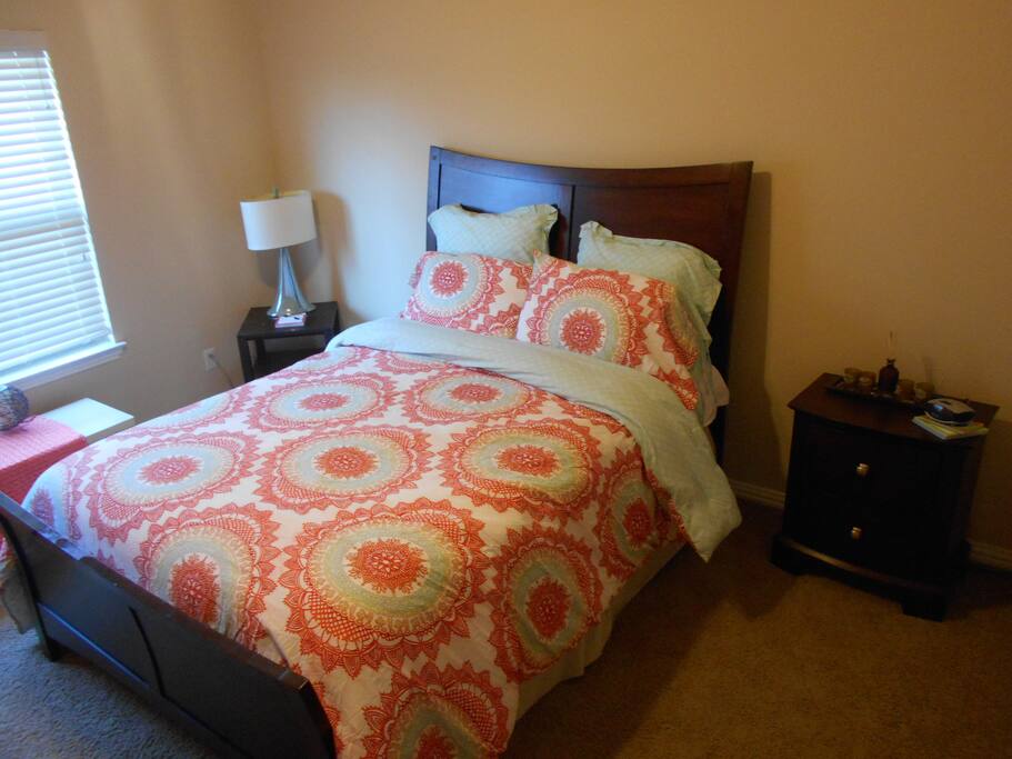 Bedroom #1 - Queen bed with night stands, lamps, ceiling fan and a large window for natural light. Thermostat for upper level is in this room.