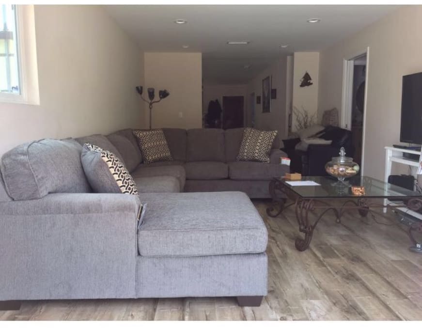 Spacious living room with sectional couch and flat screen TV