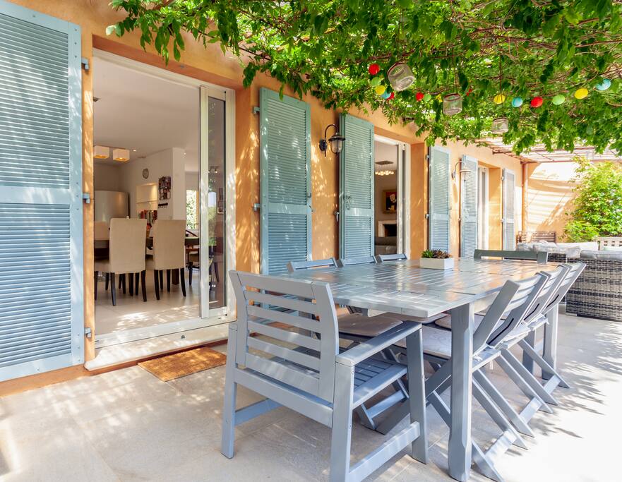 Main terrace (south-facing) shaded by vines and wisteria, has outdoor seating and gas BBQ