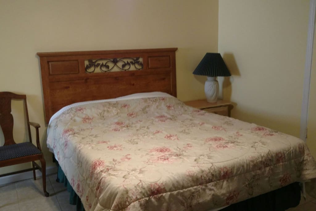 Queen size bed with extra blankets in the closet.