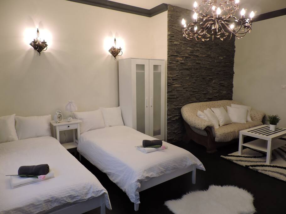 Big room with 2 single beds and double sofa bed.