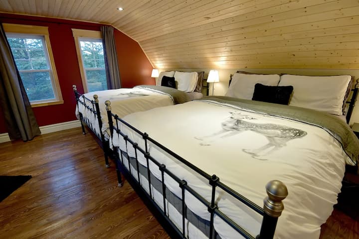 Bedroom on the mezzanine with two queen beds