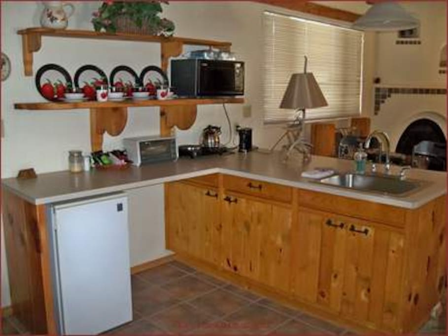 Mini-kitchen with cookware & utensils.