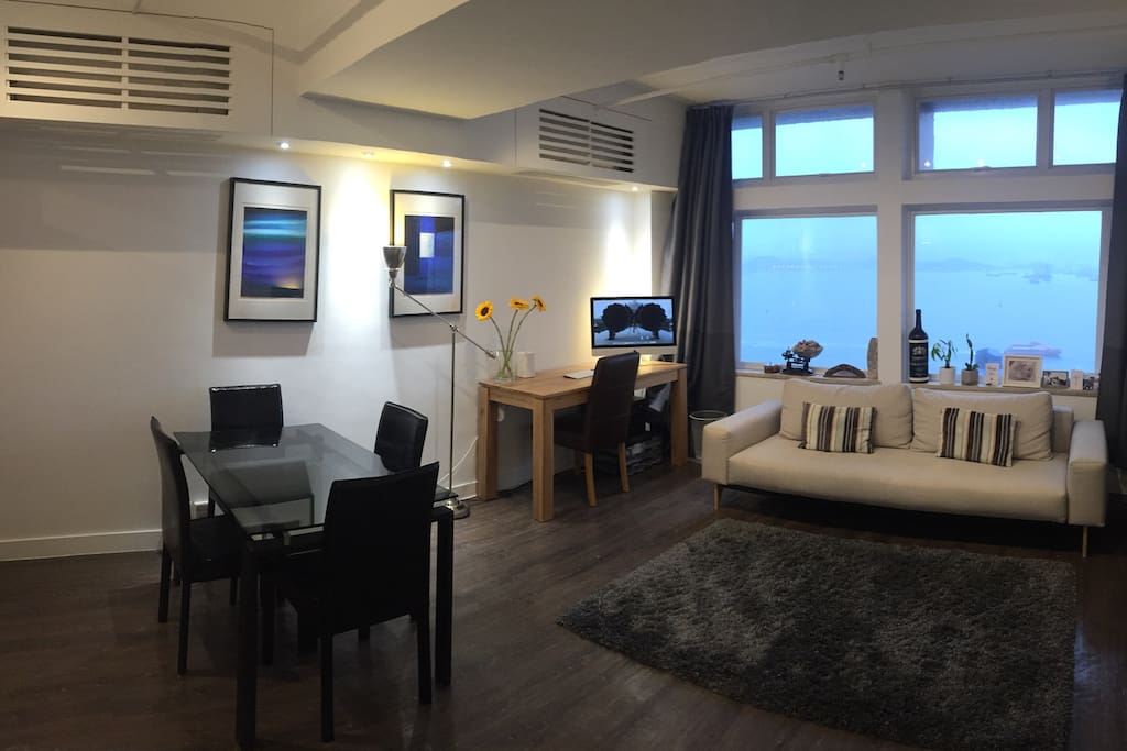 Living area with dining table, and work desk.