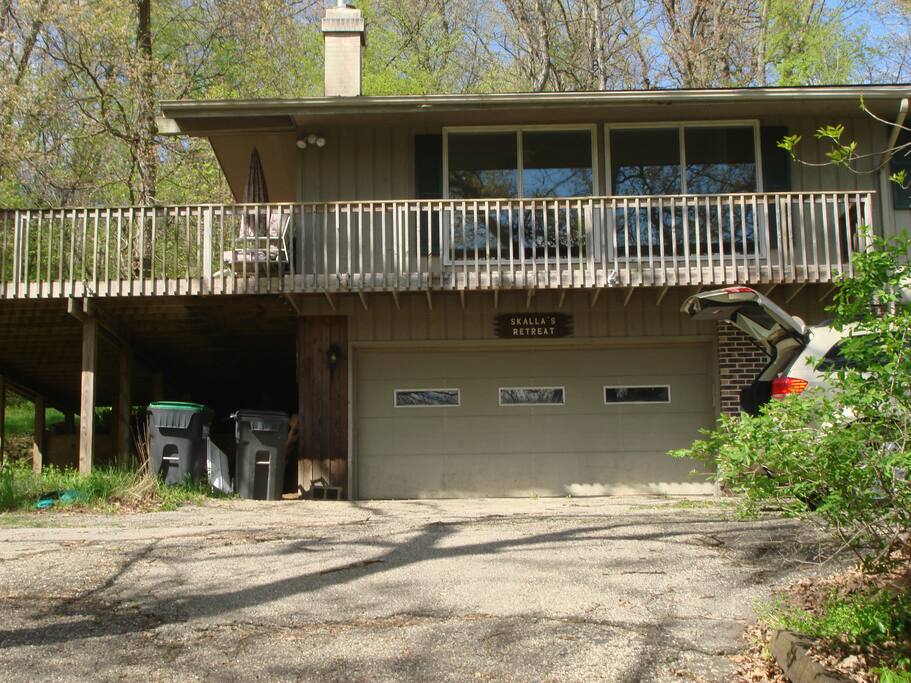 Front of house with wraparound deck/large seating area & overhanging roof