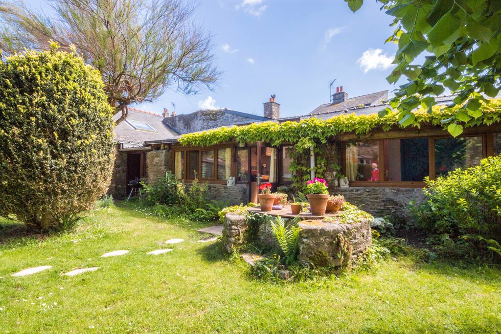 Jardin ombragé avec son mobilier et un barbecue