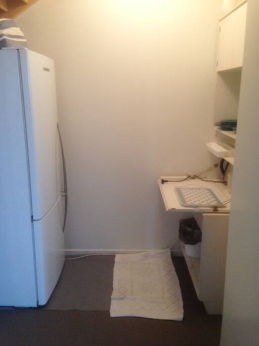 Kitchenette leading off sitting room, for storage and serving of food but not for cooking.