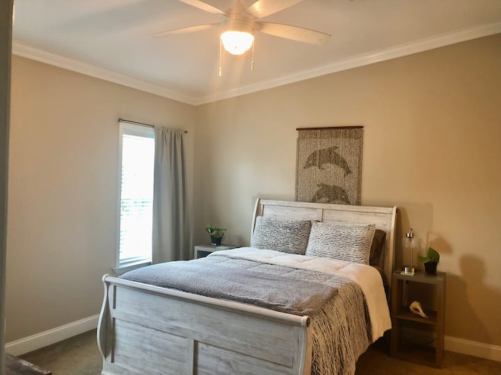 Master bedroom with queen size bed and dresser, TV, 2 windows, private bath with 2 sinks , walk in shower, no tub and walk in closet. Ceiling fan above 