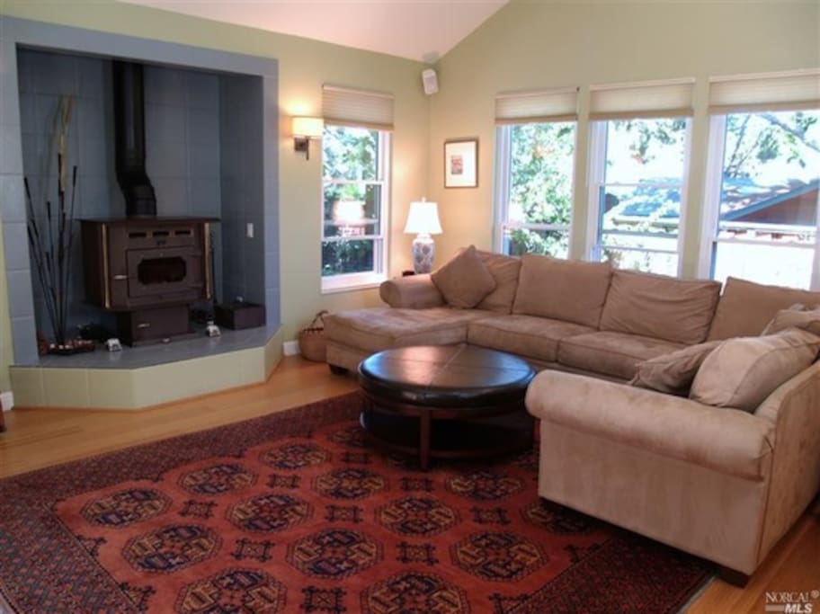 Wood burning fireplace in main room along with big screen tv and comfy couch!