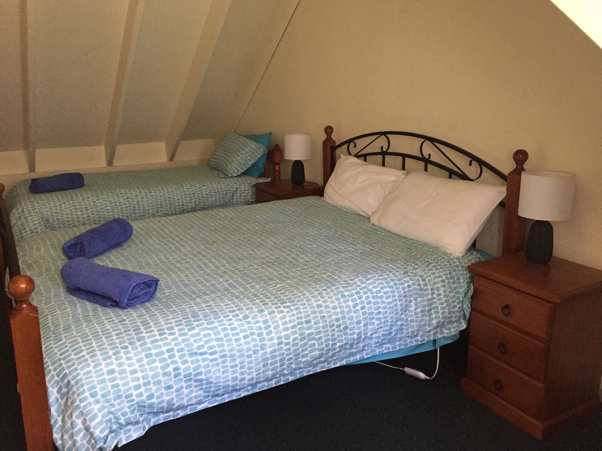 Loft bedroom containing queen size bed and a single 