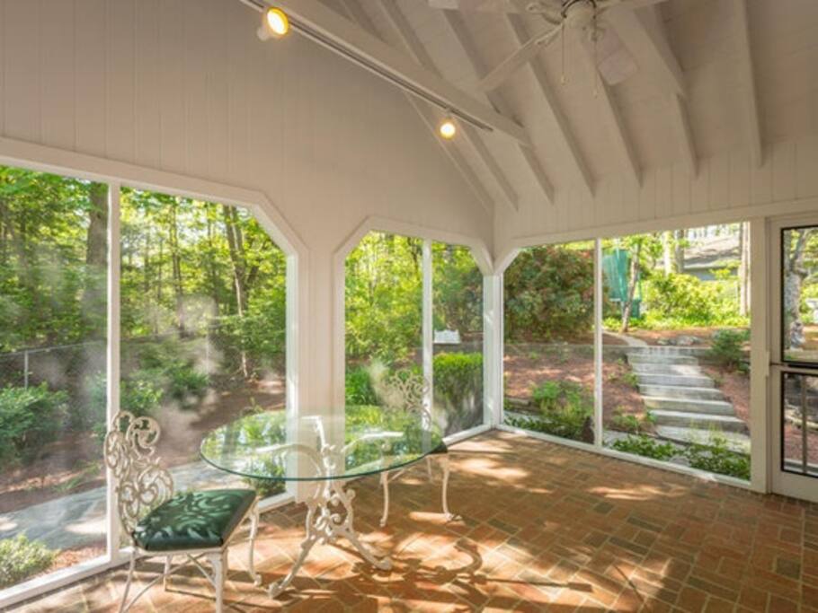 Pettit House large screened in porch . Has comfy seating for 12 on porch and attached brickbpatio has 2 tables , gas BBQ Grille, pretty night lighting outside.