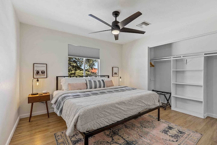 A luxurious king bed with plush cotton sheets, creating a perfect place to relax and unwind in the comfort of your own bedroom with a 40” Roku TV.