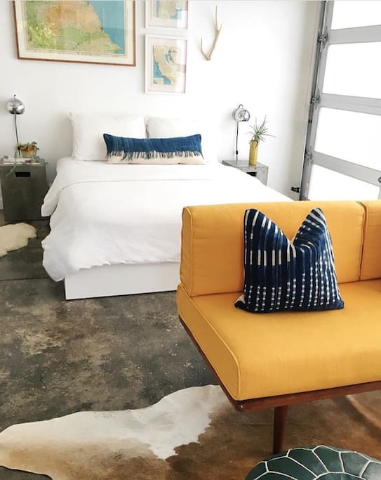 White linens and Bohemian pillows hand-crafted here in Venice decorate our sunny studio
